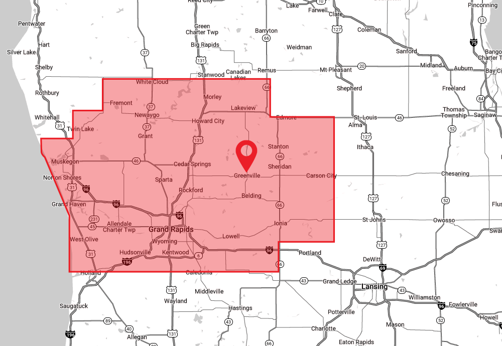 A map highlighting a specific service area in Michigan. The highlighted region encompasses areas including Muskegon, Fremont, Lakeview, Greenville, Ionia, and Grand Rapids. The highlighted area extends from the shores of Lake Michigan near Muskegon, eastward to near St. Louis and Ithaca, and from north of White Cloud and Morley, southward to near Saugatuck and Hastings. A prominent red pin is placed near the center of the highlighted area, indicating a key location.